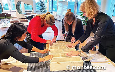 Several people build an insect hotel at a team building event in Salzburg